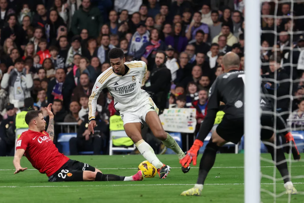 Real Madrid's English midfielder #5 Jude Bellingham in a duel with Real Mallorca's Uruguayan defender #20 Giovanni Gonzalez during the Spanish league football match at Santiago Bernabeu stadium on January 3, 2024.