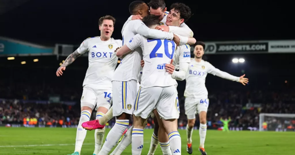 Leeds United players celebrating  comeback to win