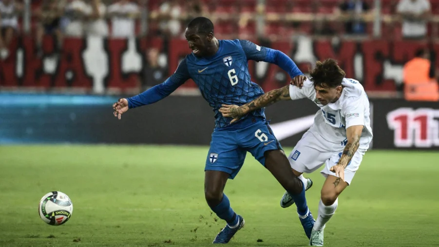 Lazaros Rota fights for the ball with Glen Kamara