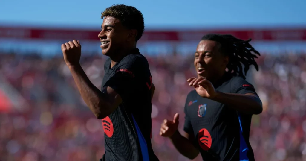 Lamine Yamal celebrating a goal with Jule Kounde