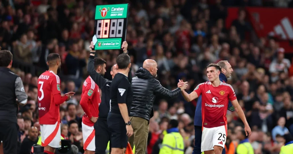 Manuel Ugarte shakes hands with Eric Ten Hag 