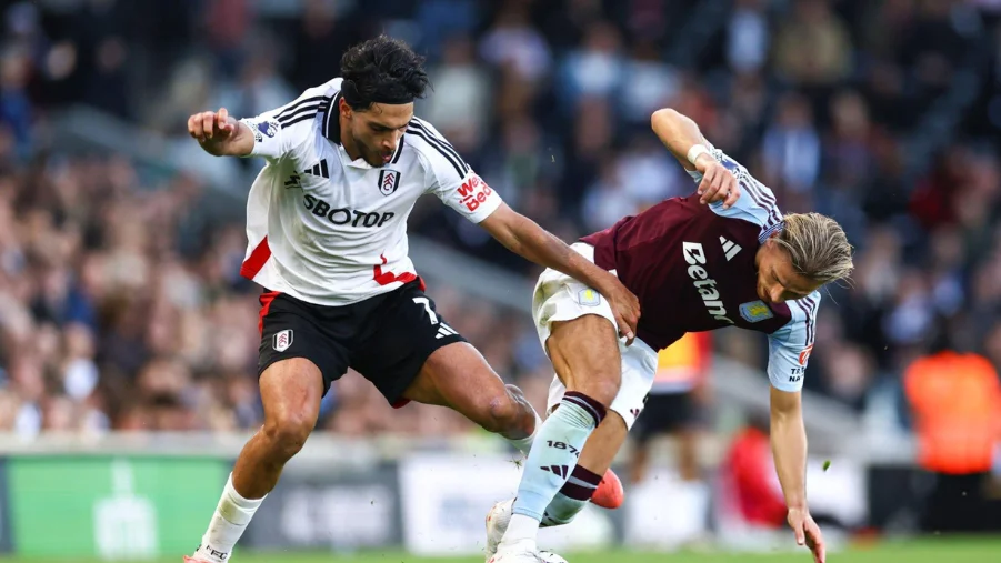 Raul Jimenez of Fulham and Matty Cash of Aston Villa during the Premier League match between Fulham FC and Aston Villa FC at Craven Cottage