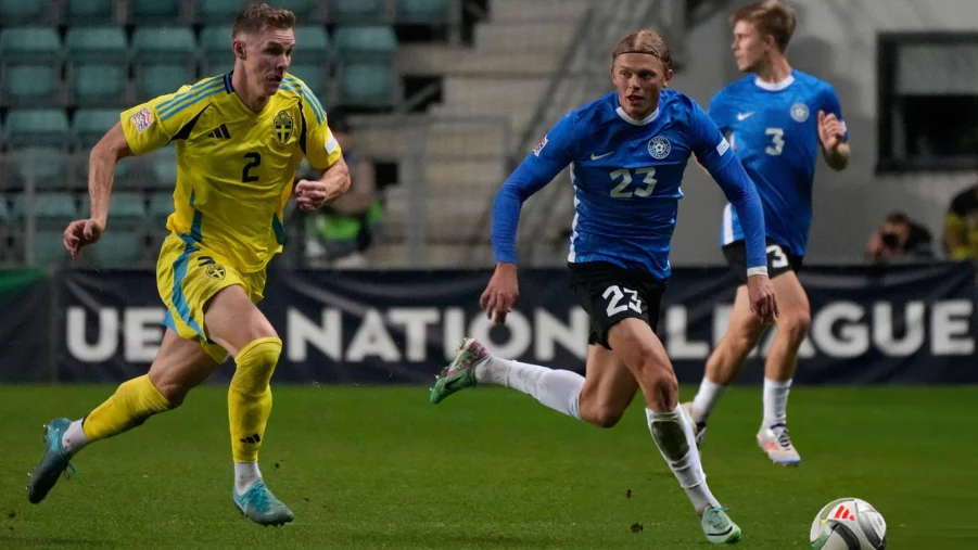 Vlasiy Sinyavskiy and Sweden's defender Emil Krafth vie for the ball 