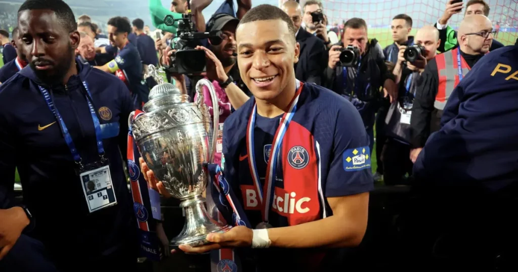 Kylian Mbappe holding the French Cup with PSG 