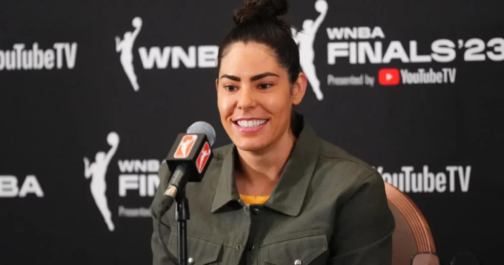 Kelsey Plum in a monochrome jumpsuit at a 2024 post-game conference.