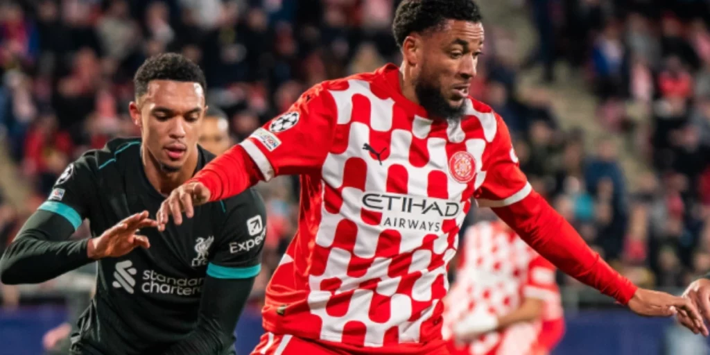 Girona's Danjuma (in Red and White) in a battle with Trent Alexander-Arnold (in Black)