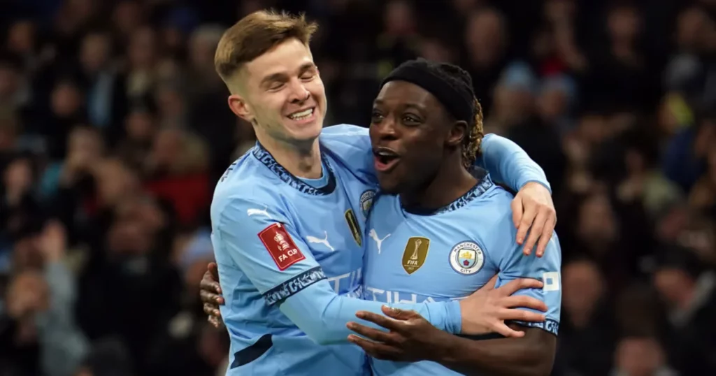 McAtee (L) and Doku celebrate a goal for Manchester City