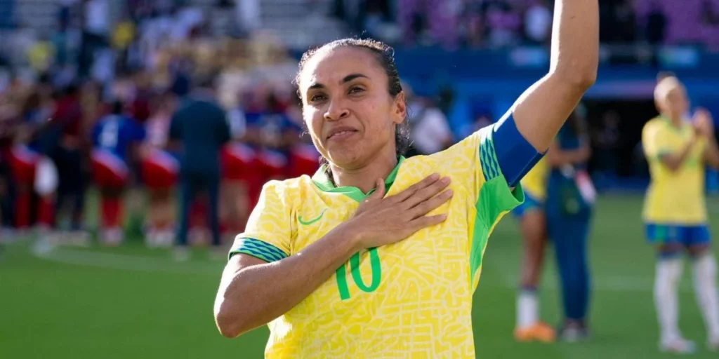 Marta gesturing towards fans