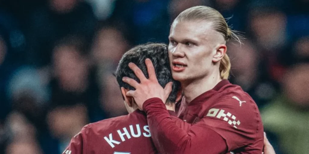 Erling Haaland celebrating his goal with Khusanov