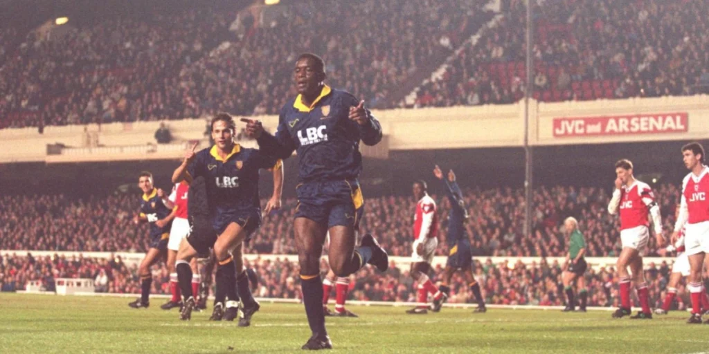 Robbie Earle celebrates after scoring against Arsenal