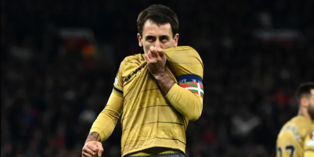 Mikel Oyarzabal kissing his badge after scoring the first goal on the night