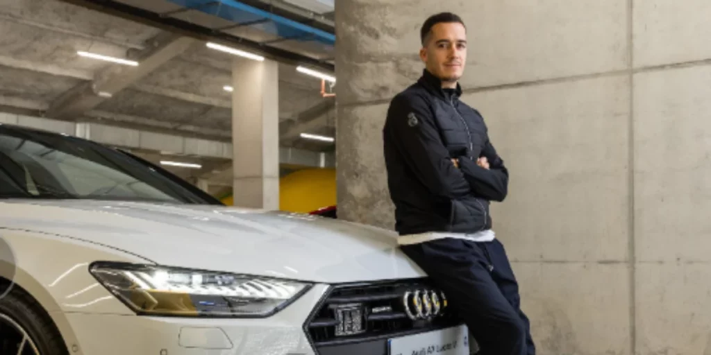 Lucas Vazquez posing with his Audi Car.