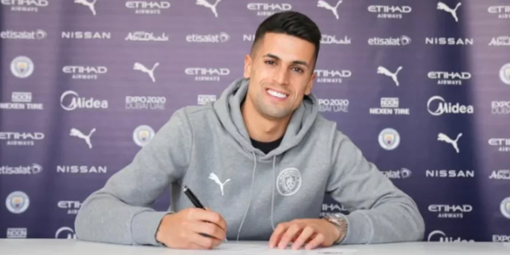 Joao Cancelo signing a contract extension with Manchester City