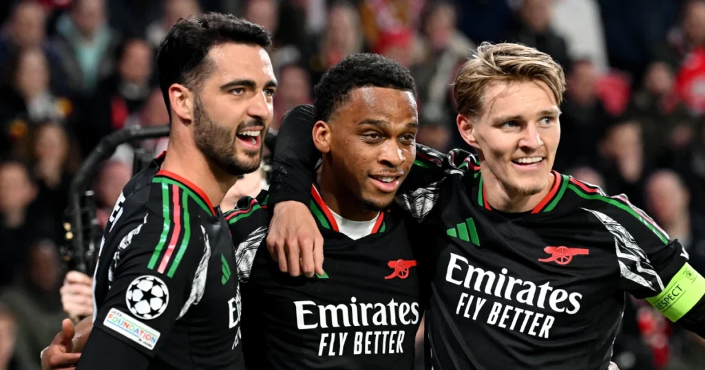 Mikel Merino, Jurrien Timber and Martin Ødegaard pose after Arsenal's first goal against PSV