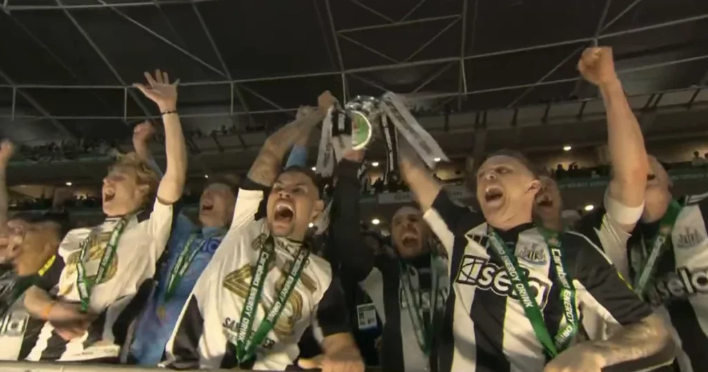 Newcastle Players celebrating with Carabao Cup trophy