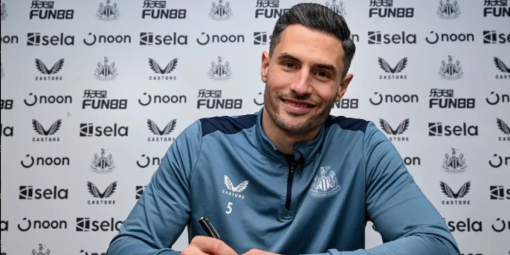 Fabian Schar signing a contract with Newcastle United.